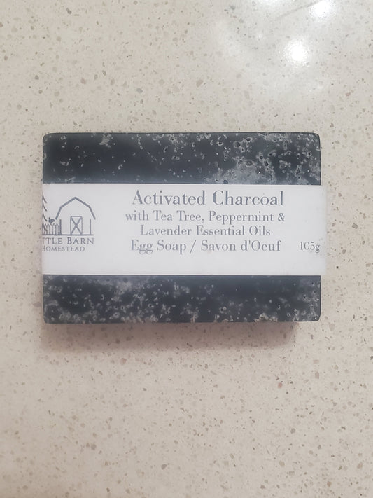 black bar of soap with activated charcoal, tea tree, pepermint & lavender essential oil